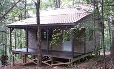 a small wooden cabin in the woods