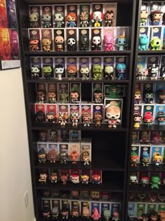 a book shelf filled with lots of pop - up action figures and vinyl figurines