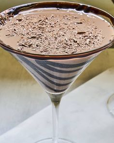 a chocolate martini in a wine glass on a table