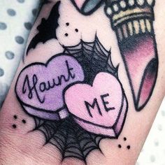 a tattoo with two hearts on it and the words maunt me written in black ink