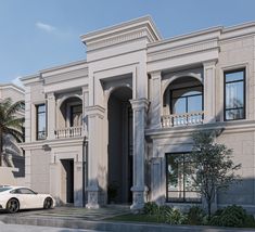 a white car is parked in front of a large, two story building with balconies