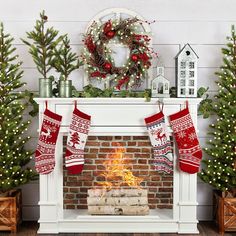 a fireplace with stockings hanging from it's sides and christmas decorations on the mantle