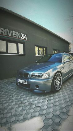 a silver car parked in front of a building