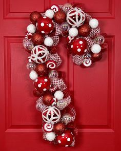 a red door decorated with christmas ornaments