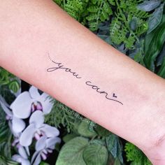 a woman's arm with the word you can written on it in cursive handwriting