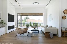 a living room filled with furniture and a flat screen tv sitting on top of a wooden floor