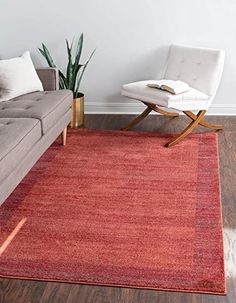 a living room with a couch, chair and rug