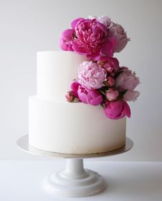 a white cake with pink flowers on top