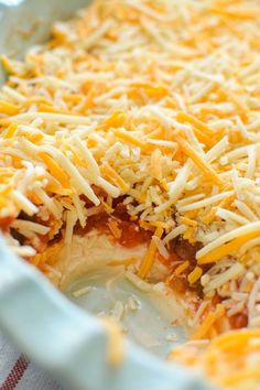 a casserole dish with cheese and sauce in it