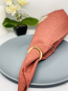 an orange napkin on top of a blue plate