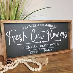 a sign that says flower market fresh cut flowers