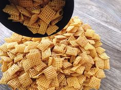 a bowl filled with cheetos sitting on top of a wooden table