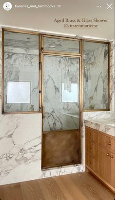 a bathroom with marble walls and wooden floors