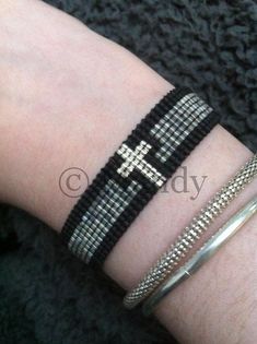 a close up of a person's arm with two bracelets on top of it