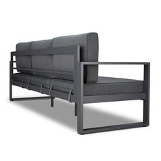 a gray couch sitting on top of a metal frame