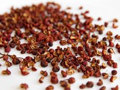 dried red pepper flakes on a white surface