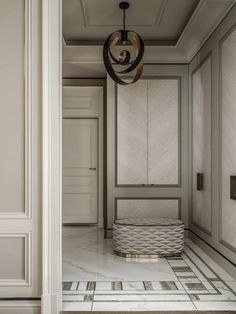 an empty room with white walls and marble flooring, chandelier hanging from the ceiling