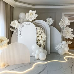 white balloons and flowers on display in a room