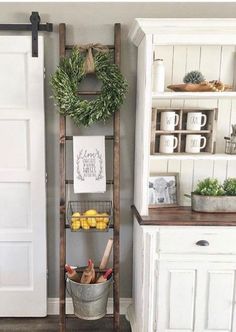 an old ladder is used as a shelf for fruit and vegetables in the kitchen area