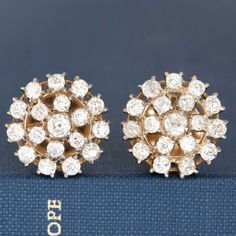 Its like wearing a disco ball on your ears! We adore this pair of antique clsuter earrings, studded with a mix of chunky old mine and old European cut diamonds in 18kt yellow gold. Super elegant on the lobes! 18kt yellow gold Measures .60" inches in diameter Diamonds are estimated to be I/K colors & VS/SI clarities. GIA Standards 5g With oversized backings Please see qualtiative report for more information. Modern Mens Rings, Diamond Cluster Earrings, Old Mine Cut Diamond, Jewel Necklace, European Cut Diamonds, Vintage Band, Cluster Earrings, Disco Ball, Diamond Cluster