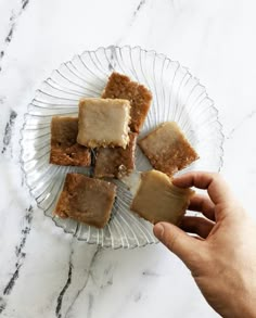 a person is holding some food on a glass plate