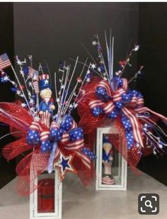 two red, white and blue patriotic decorations on display in front of a black background