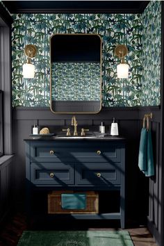 a bathroom with blue vanity and green wallpaper