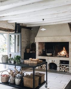 a living room filled with furniture and a fire place in the middle of an open floor plan