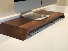 an apple computer sitting on top of a wooden desk