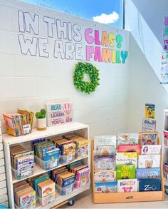 the children's books are on display in the library and there is a sign that says in this class we are family