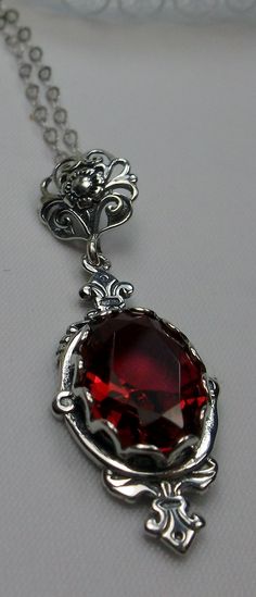 "Simulated Ruby Pendant Necklace & Earrings Pin Design#P18 Custom-Made This Victorian reproduction estate Pendant is created in solid sterling silver. This pendant has a stunning 6 carat oval cut simulated red ruby. Dimensions of the pendant are 1 5/8\" tall and 9/16\" wide. The sterling silver chain (if chosen) is adjustable from 18\" to 20\". The earrings each have 6 carat oval cut gems that are 14mm x 10mm. The total earrings are 1 3/4\" long. This is an amazing reproduction of Victorian Ornate Red Pendant Jewelry, Camphor Glass Jewelry, Delicate Jewellery, Ruby Necklace Pendant, Pin Design, Ruby Pendant, Ruby Necklace, Luxury Rings, Sterling Silver Filigree