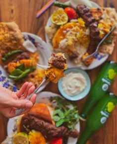 a person holding a fork with food on it