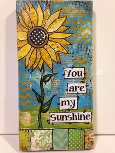 a sunflower painted on a piece of wood with words that say you are my sunshine