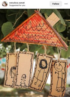 some paper tags hanging from a tree with pictures on them and the words, i love you