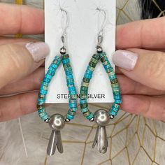 1/2 PRICE! NAVAJO Native American Kingman Turquoise, Navajo Pearl, Sterling Squash Blossom Heishi Drop Dangle Earrings! Handmade Earrings.  The turquoise is very blue green! So Stylish!  See Pics and Video for Details.  Pair with Navajo Pearls and your other Native American jewelry.  These earrings weigh approx. 6 grams each. Artist: Handmade by Navajo artist Corraine Smith Retail Price: $175.00 Our Price: $87.50 Shipping: FREE IMPORTANT NOTE: See the photos to verify the specifics of this beaut Navajo Pearls, Southwest Jewelry, Native American Turquoise, Squash Blossom, Jewelry Show, Kingman Turquoise, Drop Dangle Earrings, American Jewelry, Native American Jewelry