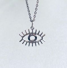 "Silver Evil Eye necklace, protection from the evil eye, with STAINLESS STEEL dainty chain. Eye of Horus necklace, Eye of Ra, Egyptian jewelry, ancient Greece. Witchy Woman Wicca, mall goth gothic aesthetic. *STAINLESS STEEL chain *chain measures approx 18\" long *charm measures approx 0.7\" *has lobster claw claps closure *charm is silver alloy *comes in gift box" Eye Pendant, Evil Eye Necklace Silver, Eye Of Horus Necklace, Silver Necklace Designs, Eye Of Ra, Eye Of Horus, Egyptian Jewelry, Teardrop Necklace, Jewelry Card