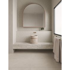 a bathroom with a sink, mirror and towel on the rack next to the window