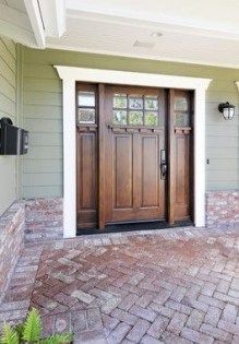 a house with two doors and brick walkway