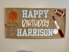 a happy birthday banner with sports items on it and the words harrison written in white