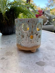 a ceramic candle holder sitting on top of a table