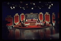 two men sitting on stage in front of a sign that says passbook with an american flag