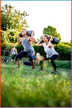 two people are doing squats in the grass while one person is holding a kettle