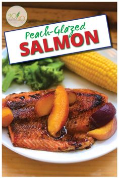 peach glazed salmon on a white plate with corn and broccoli in the background