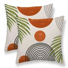 two pillows with orange and green designs on them