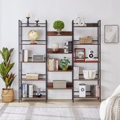 a living room filled with lots of furniture and bookshelves on top of each other