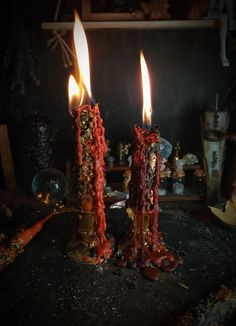 two lit candles sitting on top of a table