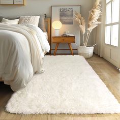 a bedroom with a large white rug on the floor