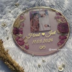 a photo frame with flowers and pearls around it