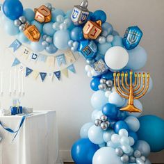 blue and silver balloons are arranged in the shape of a hanukkah menorah