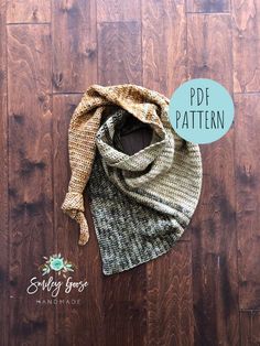 a knitted scarf on top of a wooden floor next to a sign that says pdf pattern